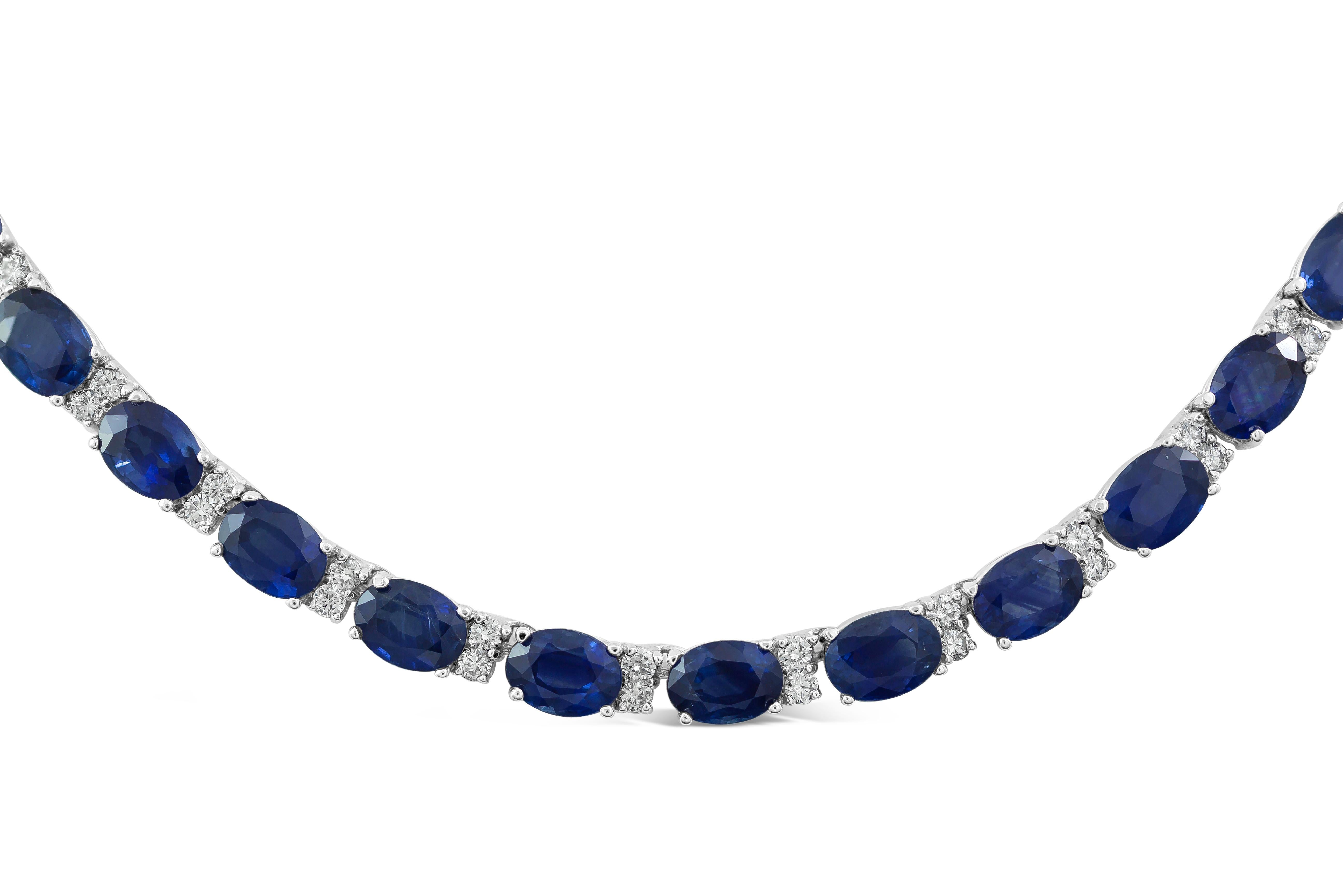 An incredibly color-rich tennis necklace showcasing  an amazing 43.86 carats total of oval cut blue sapphires set in 18 karat white gold. Each sapphire is elegantly spaced by 2 round brilliant diamonds. Approximately 16 inches in length.

Style