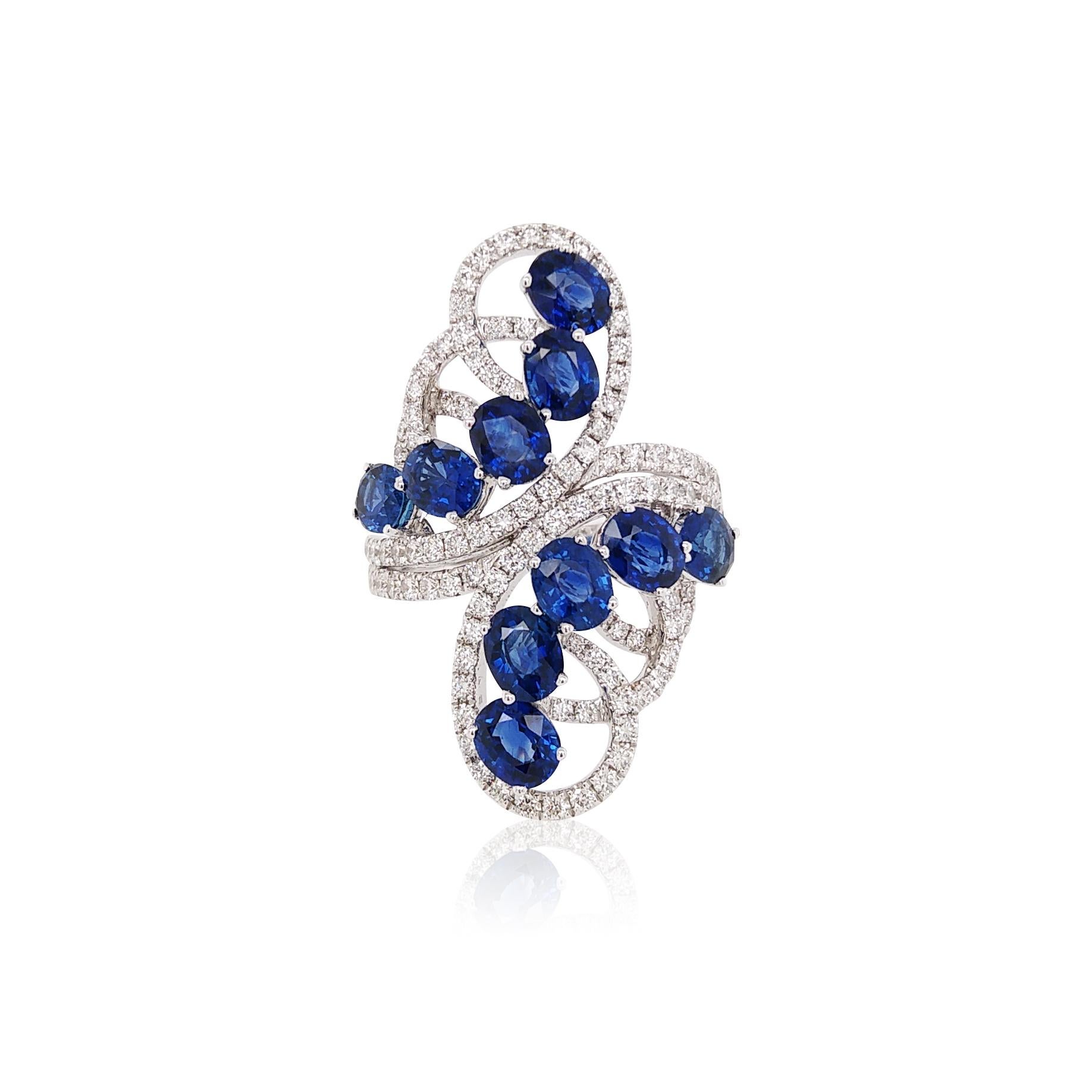 Stunning Cocktail Ring featuring a vibrant blue sapphire surrounded by dazzling white diamonds, all set in lustrous 18K gold. A bold and luxurious statement piece perfect for adding glamour to any evening look.

Oval cut Blue Sapphire- 4.8 cts
Round