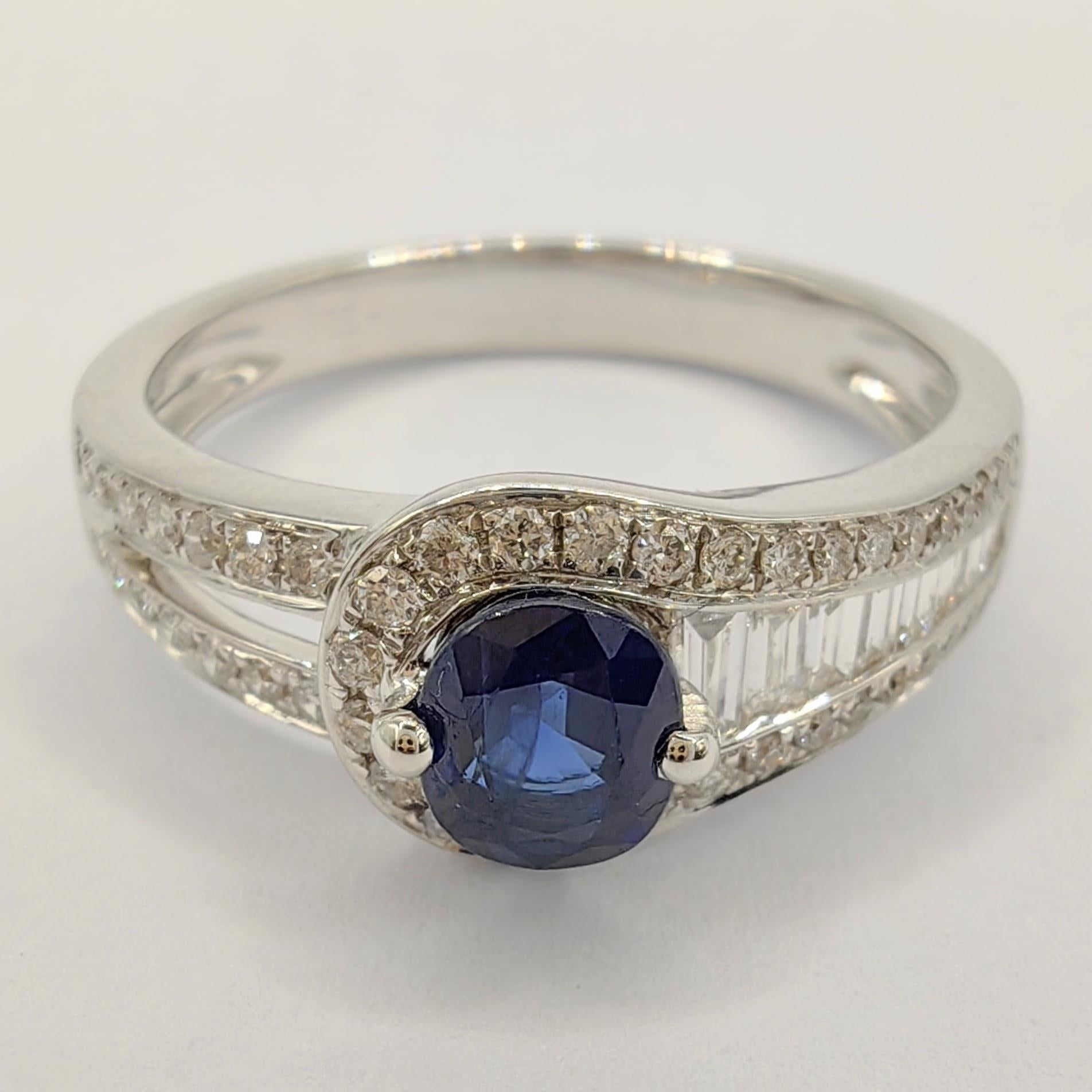 Introducing our stunning Oval-cut Blue Sapphire Tapered Baguette Diamond Ring, a piece of jewelry that perfectly balances simplicity and elegance. The centerpiece of this ring is a beautiful 0.65ct oval-cut blue sapphire, which is surrounded by a