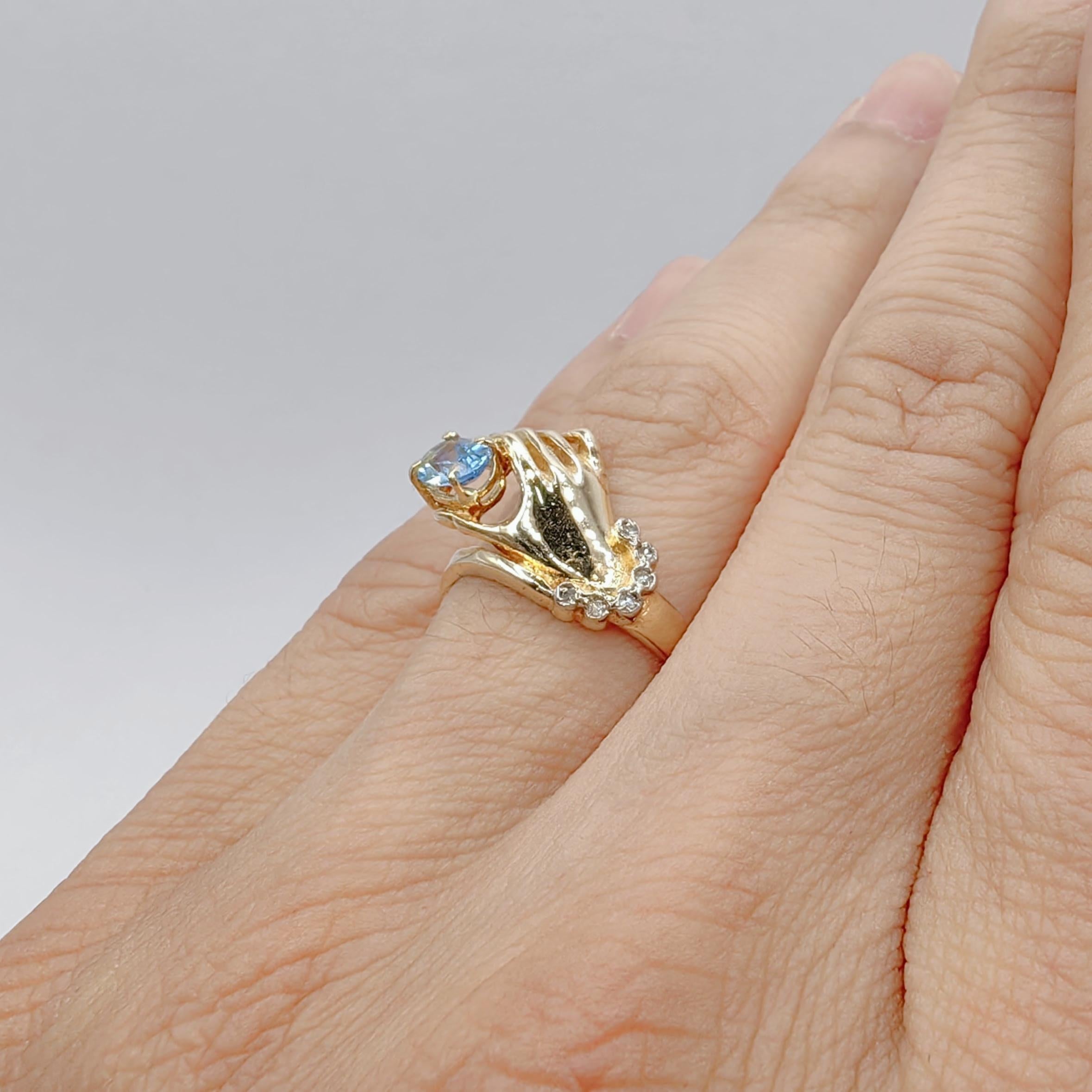Oval-cut Blue Topaz in a Hand Diamond Ring in 14K Yellow Gold For Sale 4