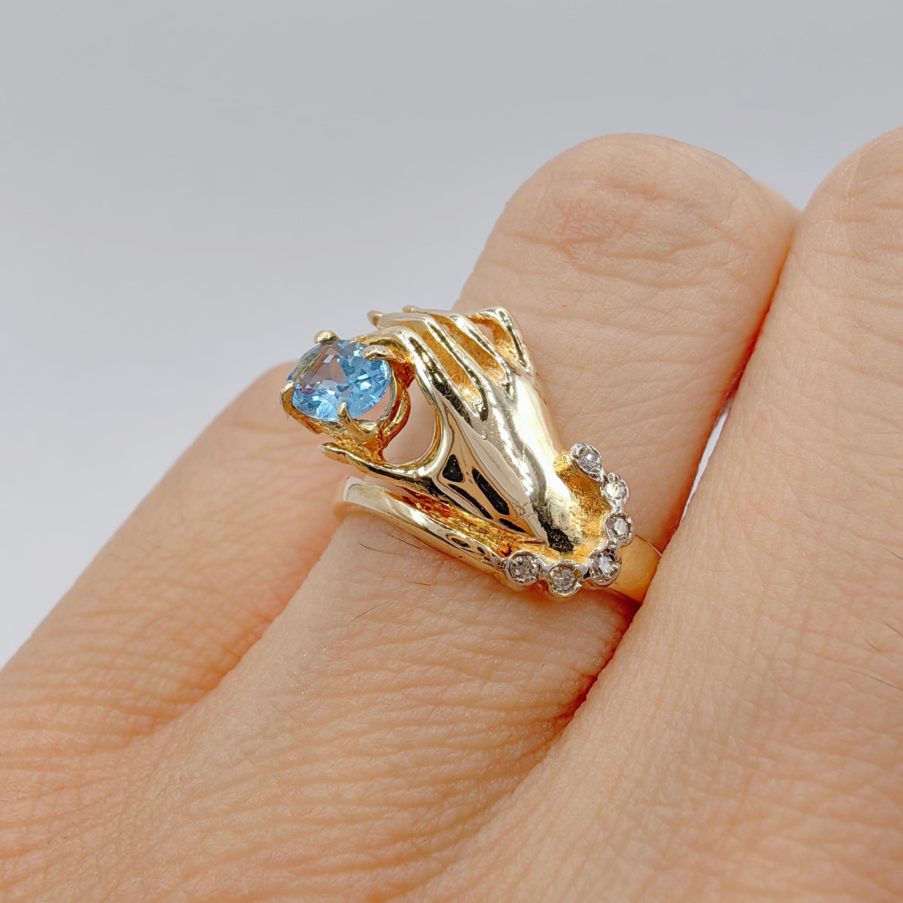 Oval-cut Blue Topaz in a Hand Diamond Ring in 14K Yellow Gold For Sale 4