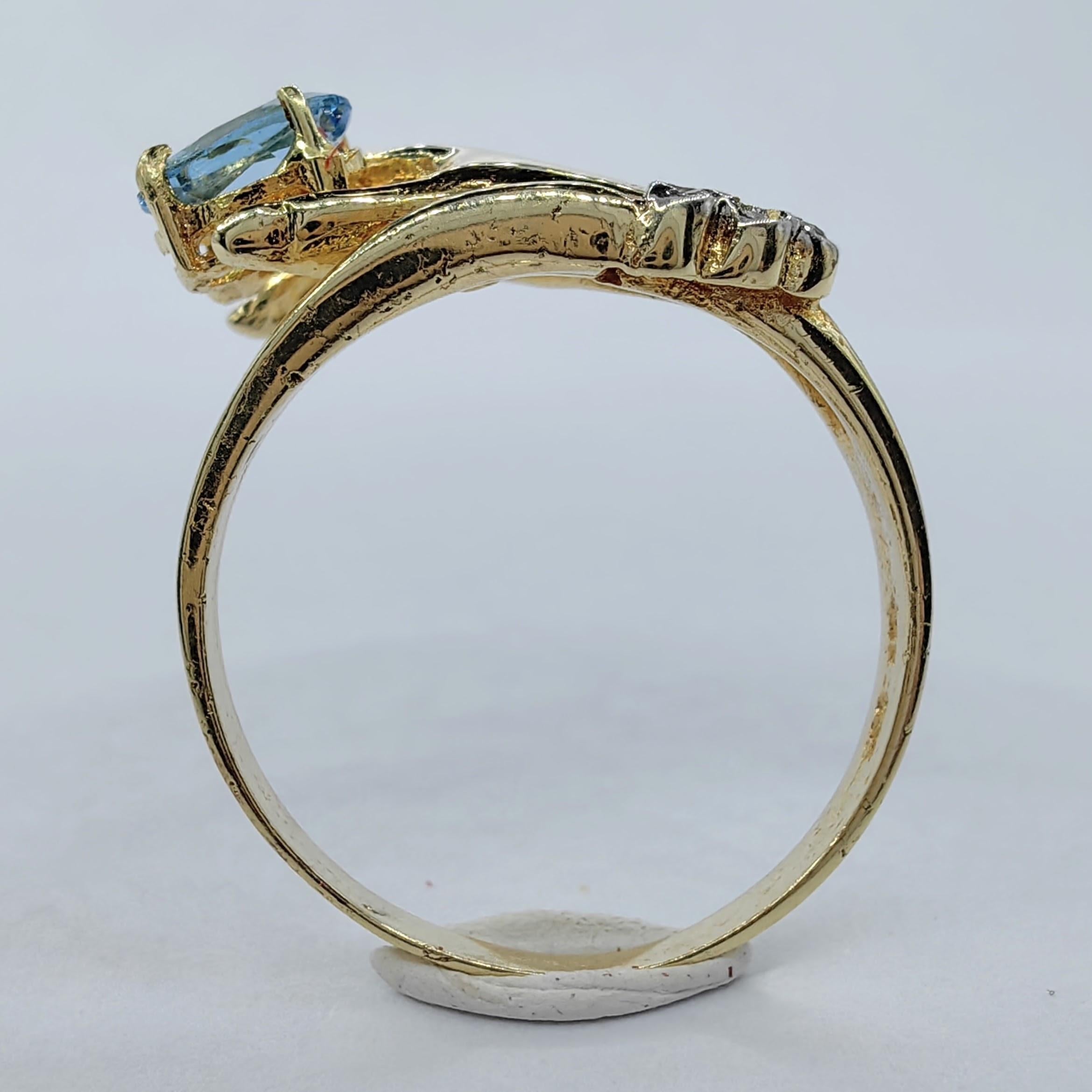 Women's Oval-cut Blue Topaz in a Hand Diamond Ring in 14K Yellow Gold For Sale