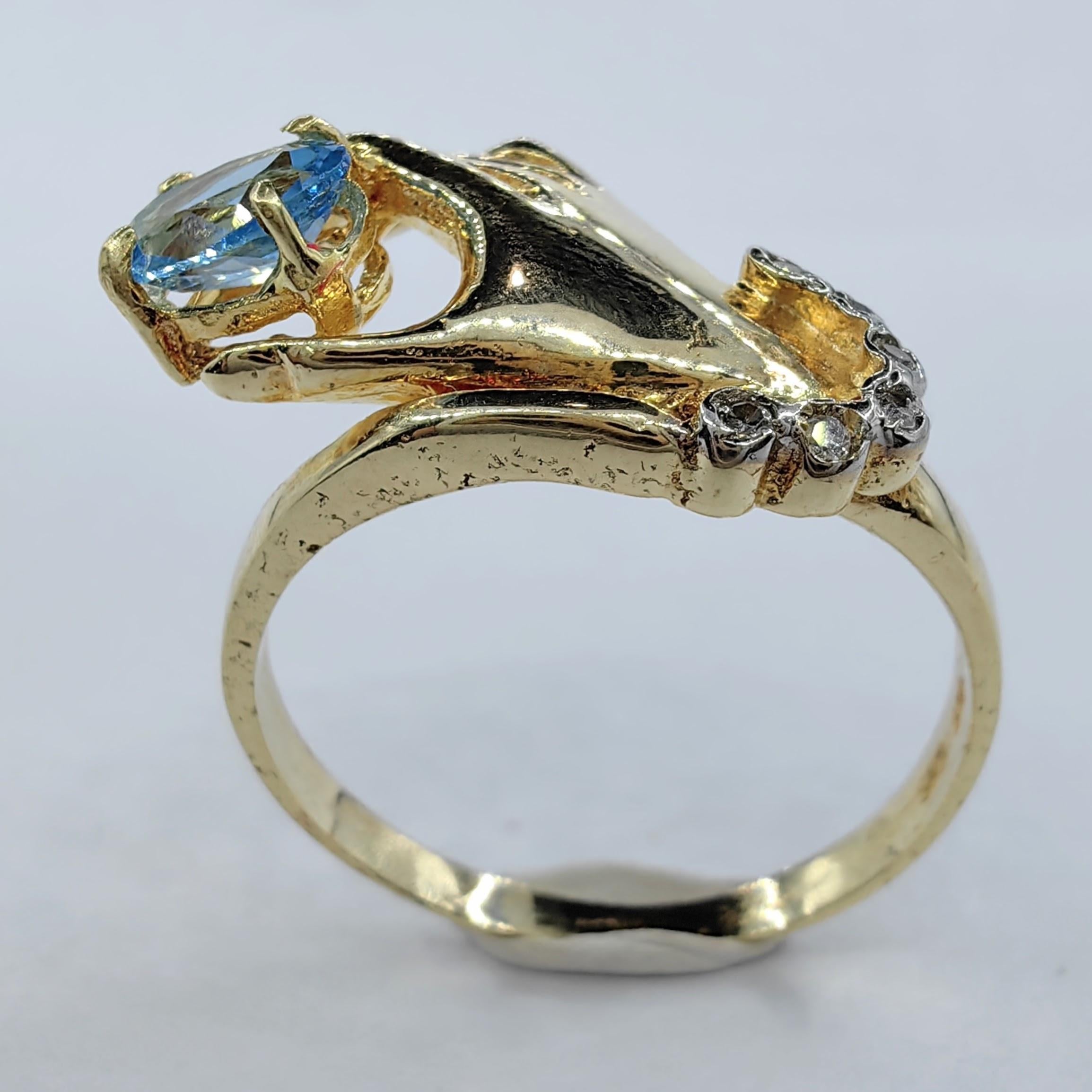 Oval-cut Blue Topaz in a Hand Diamond Ring in 14K Yellow Gold For Sale 1