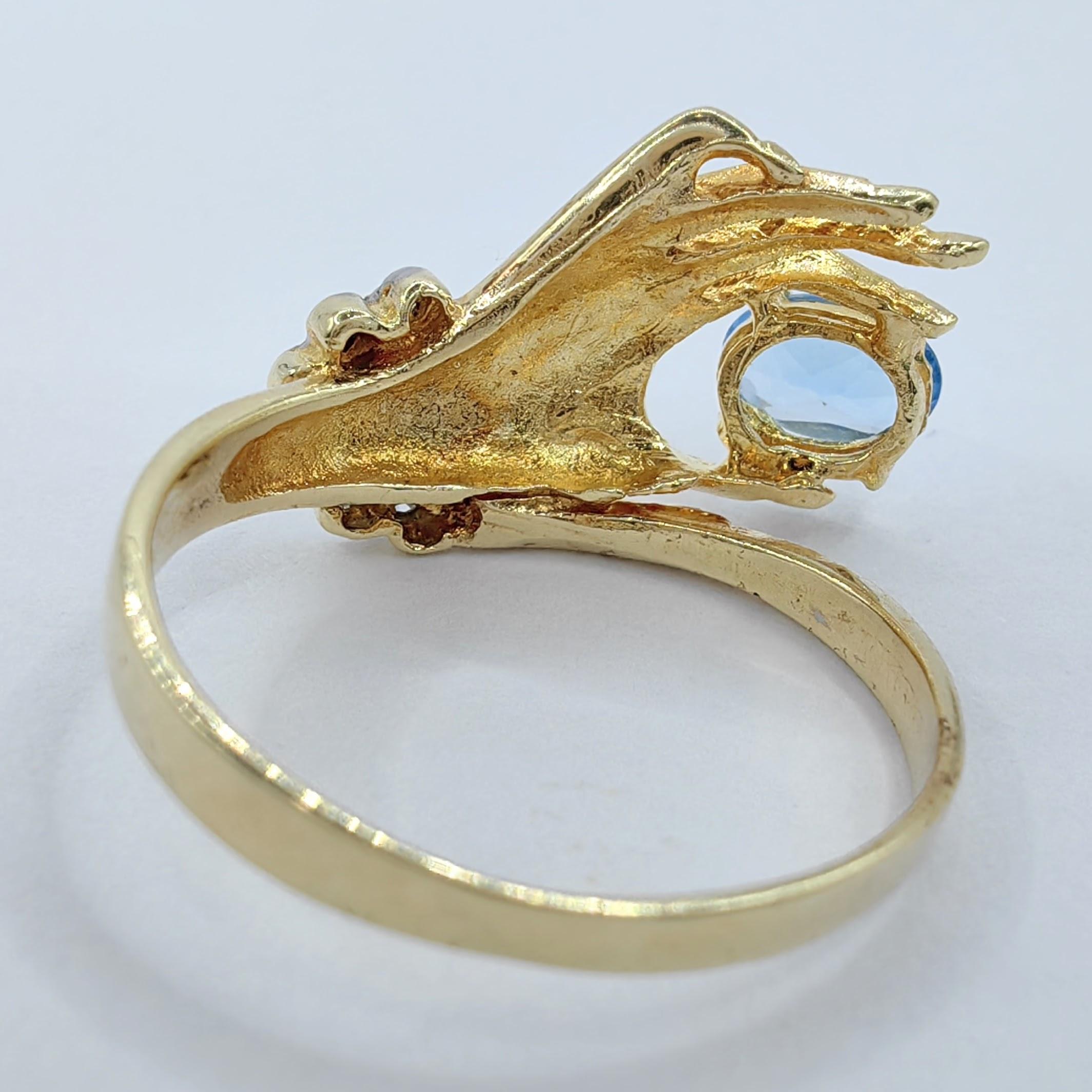 Oval-cut Blue Topaz in a Hand Diamond Ring in 14K Yellow Gold For Sale 2