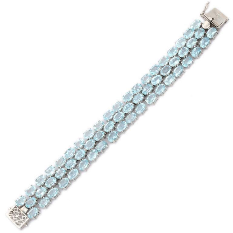 Beautifully handcrafted silver Blue Topaz Three Row Tennis Bracelets, designed with love, including handpicked luxury gemstones for each designer piece. Grab the spotlight with this exquisitely crafted piece. Inlaid with natural blue topaz