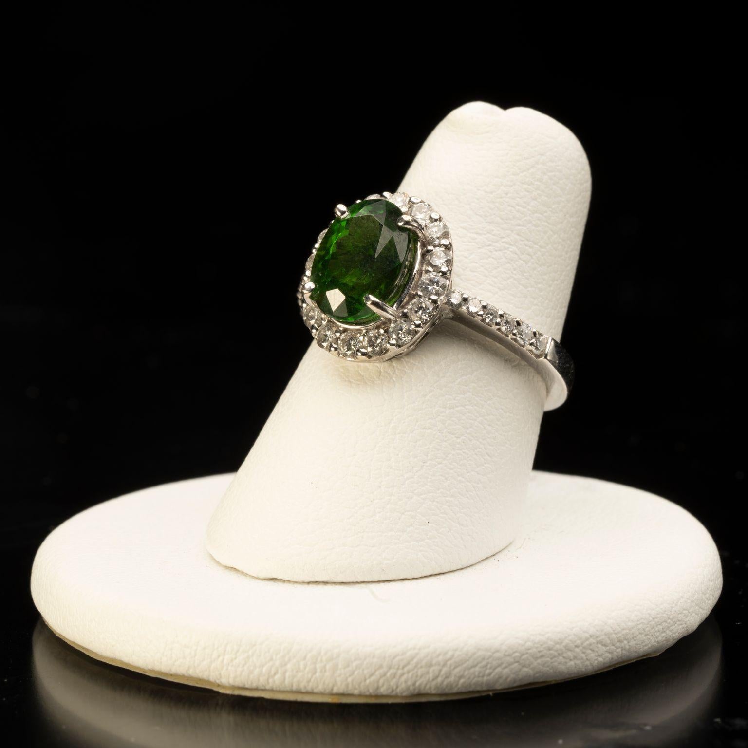 This sparkling green-drenched chrome tourmaline is set off brilliantly by a generous display of white diamonds in an intricately tooled 14 karat white gold setting on a 14 karat white gold band for an elegant ring certain to stun.

Size: