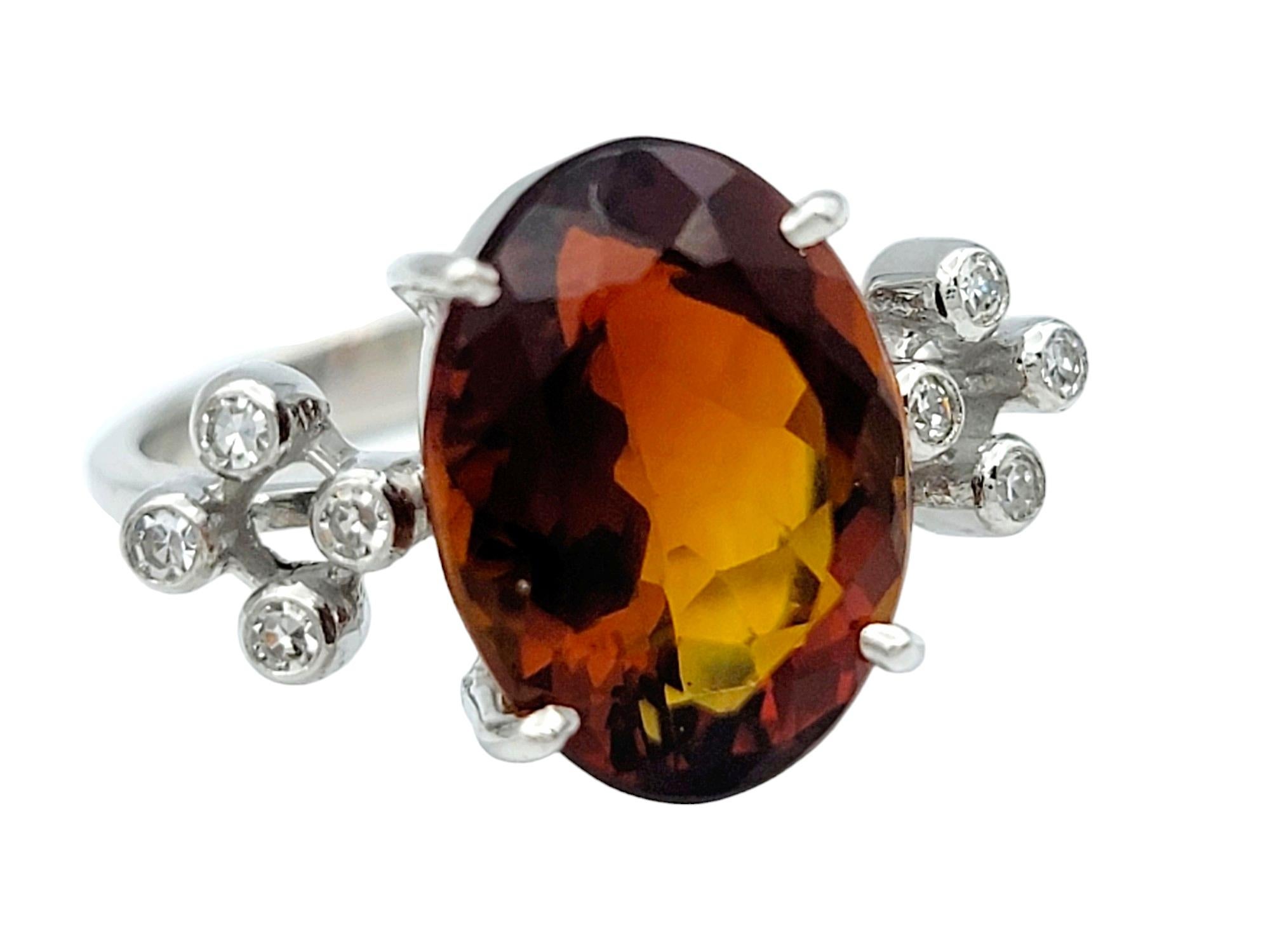 Ring Size: 5.75

Crafted with exquisite detail, this unique ring showcases a striking oval citrine at its center, boasting a deep orangy-brown hue that exudes warmth and sophistication. The citrine is complemented by a halo of dazzling diamonds,