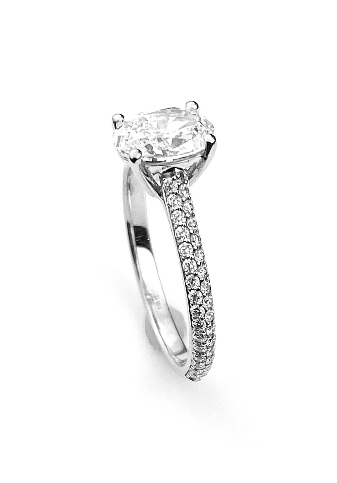 Contemporary Oval Cut Diamond Solitaire Engagement Ring with Pavé Set Diamond Band For Sale