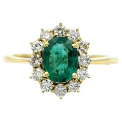 Oval Cut Emerald and Diamond Halo Cocktail Ring in 18 Karat Yellow Gold