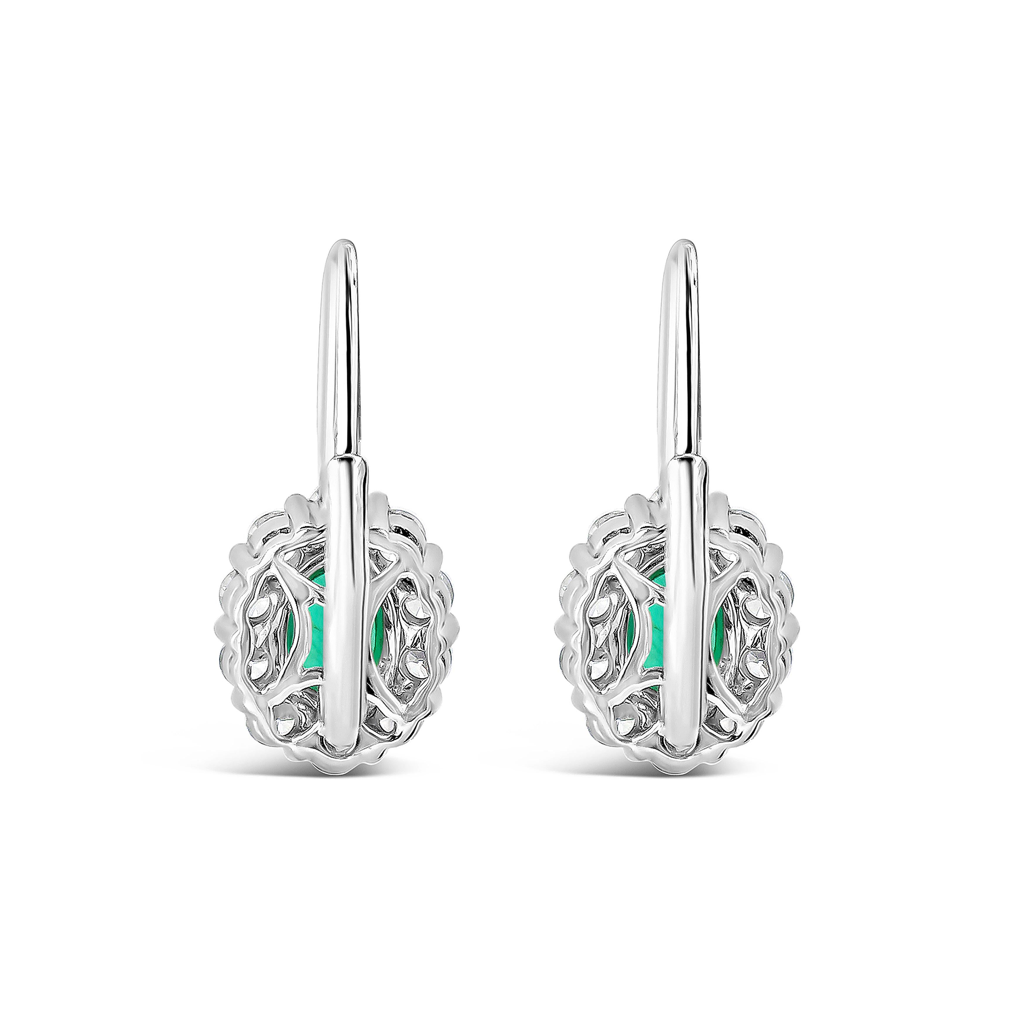 Contemporary Roman Malakov 0.78 Carat Oval Cut Emerald and Diamond Halo Lever-Back Earrings For Sale