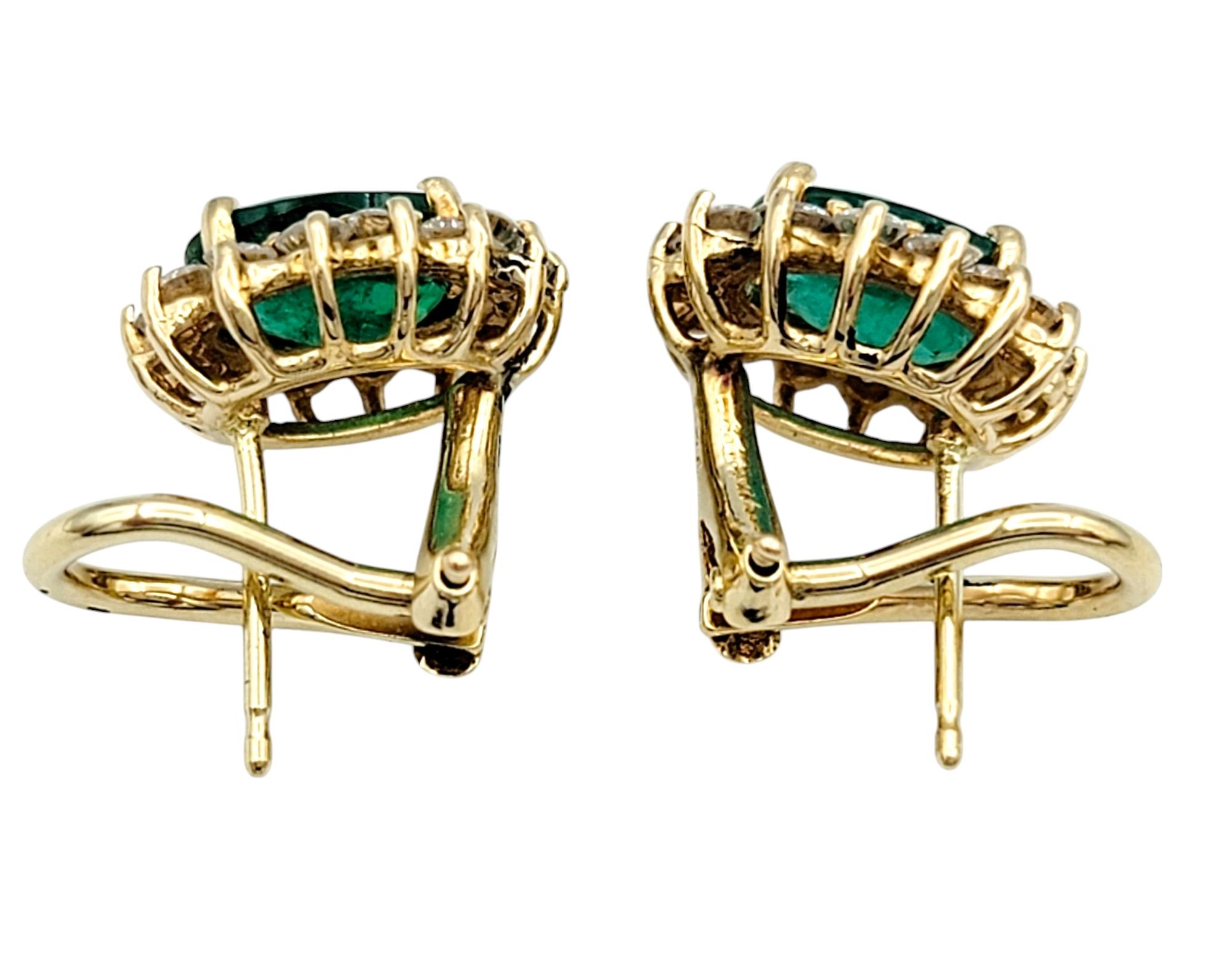 Oval Cut Emerald and Diamond Halo Stud Earrings in Polished 14 Karat Yellow Gold For Sale 1