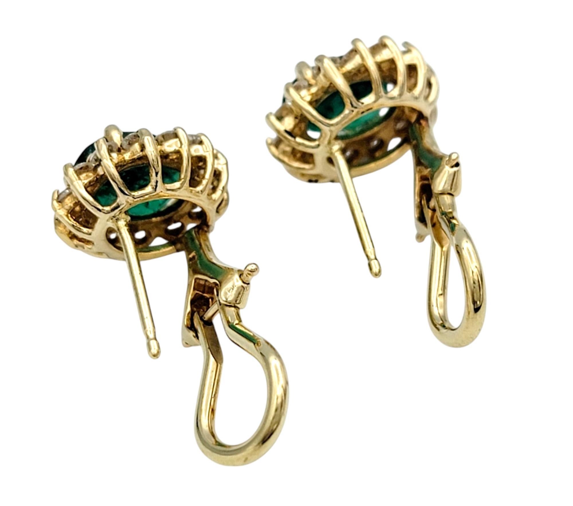 Oval Cut Emerald and Diamond Halo Stud Earrings in Polished 14 Karat Yellow Gold For Sale 2