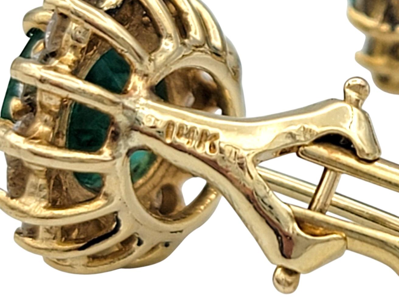 Oval Cut Emerald and Diamond Halo Stud Earrings in Polished 14 Karat Yellow Gold For Sale 3