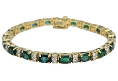 Oval Cut Emerald and Diamond Link Bracelet in Polished 14 Karat Yellow Gold
