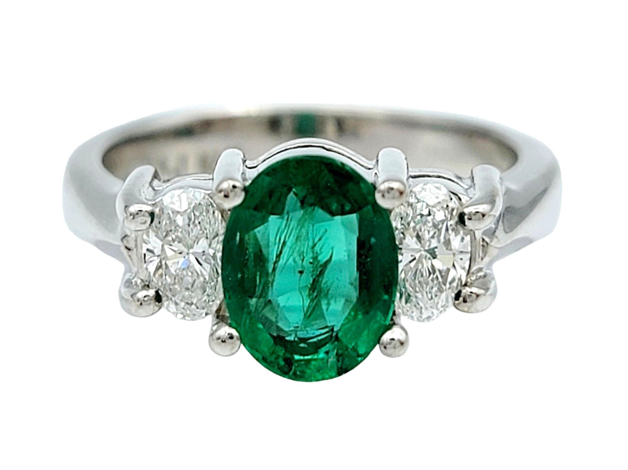 Contemporary Oval Cut Emerald and Diamond Three Stone Ring in Polished 14 Karat White Gold For Sale