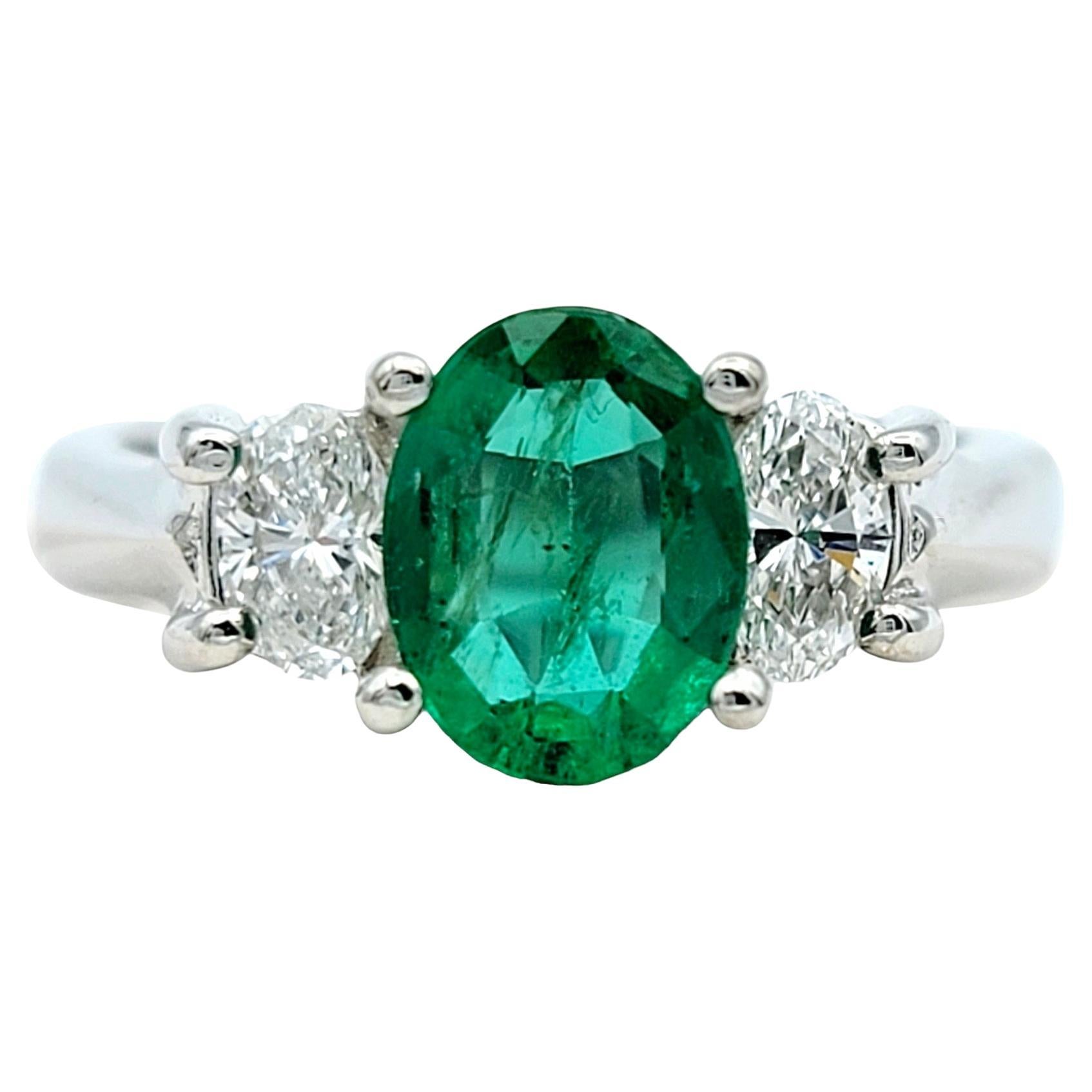 Oval Cut Emerald and Diamond Three Stone Ring in Polished 14 Karat White Gold For Sale
