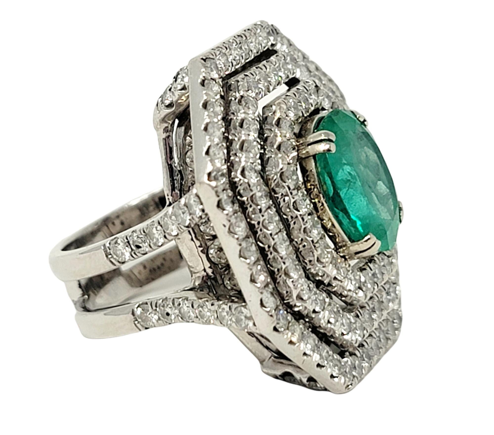 Women's Oval Cut Emerald and Diamond Triple Halo Split Shank Cocktail Ring 14 Karat Gold For Sale