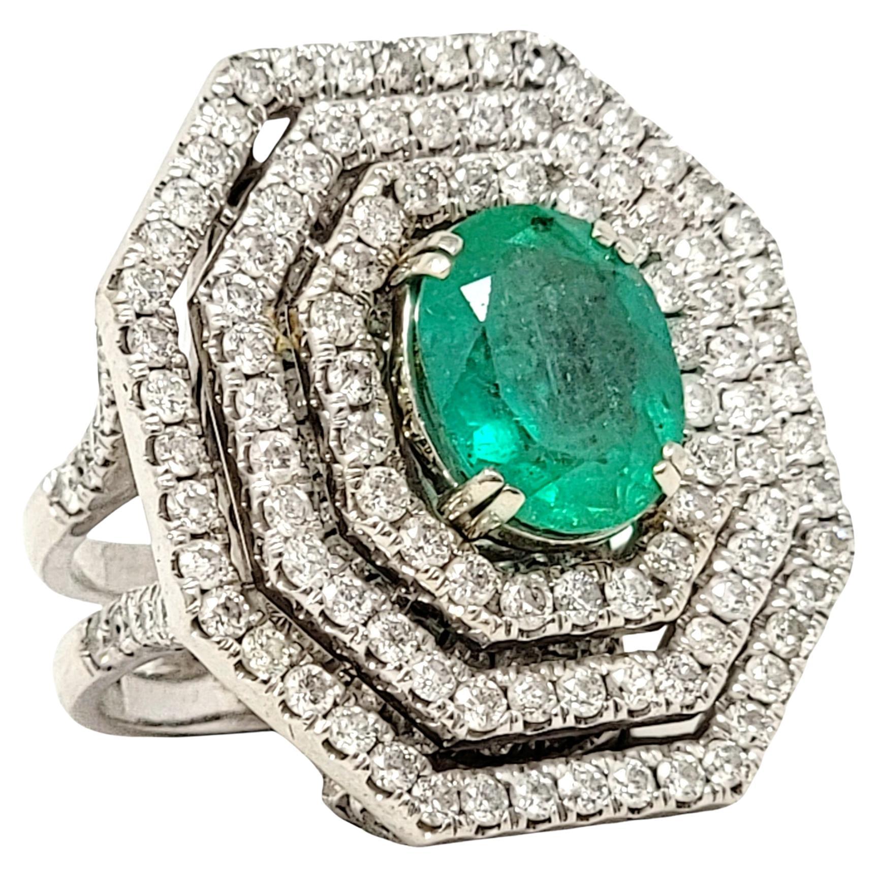 Oval Cut Emerald and Diamond Triple Halo Split Shank Cocktail Ring 14 Karat Gold For Sale