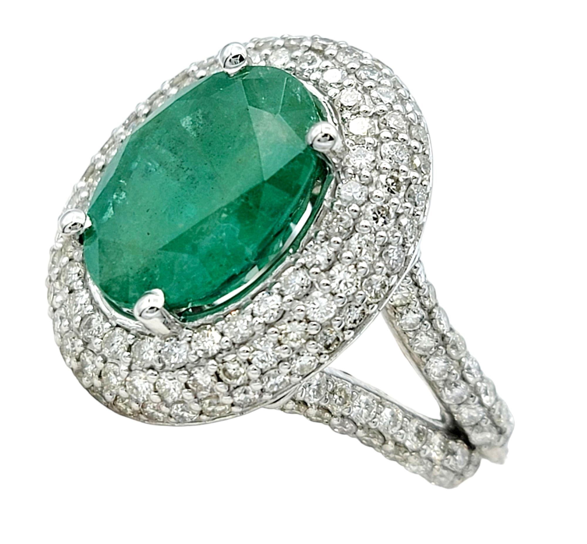 Ring Size: 6.25

This breathtaking emerald and diamond cocktail ring, set in dazzling 14 karat white gold, is the epitome of sophistication. The focal point of this luxurious piece is a captivating oval emerald, its rich green hue commanding
