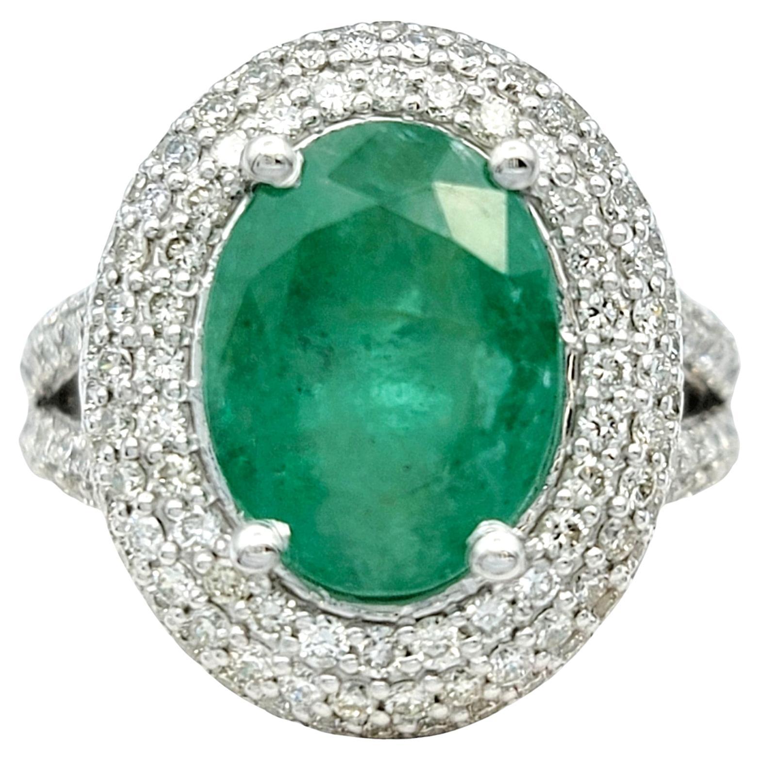 Oval Cut Emerald and Pavé Diamond Double Halo Cocktail Ring 14 Karat White Gold For Sale