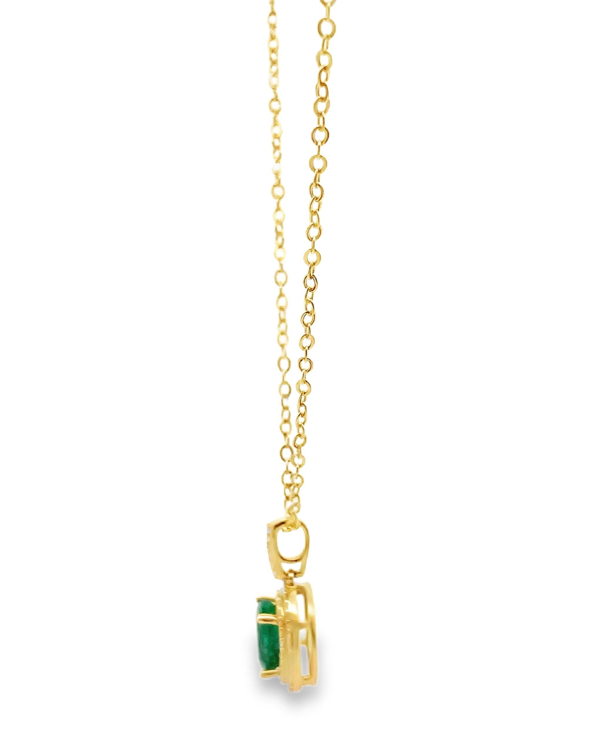 14K yellow gold pendant necklace with round faceted diamonds weighing 0.32 carat total.  In the center one oval emerald weighing 1.68 carats. 

- Necklace is 18 inches long
- Diamonds are G/H color, SI clarity