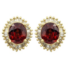 Oval Cut Garnet and Baguette Diamond Halo Stud Earrings in 14 Karat Yellow Gold