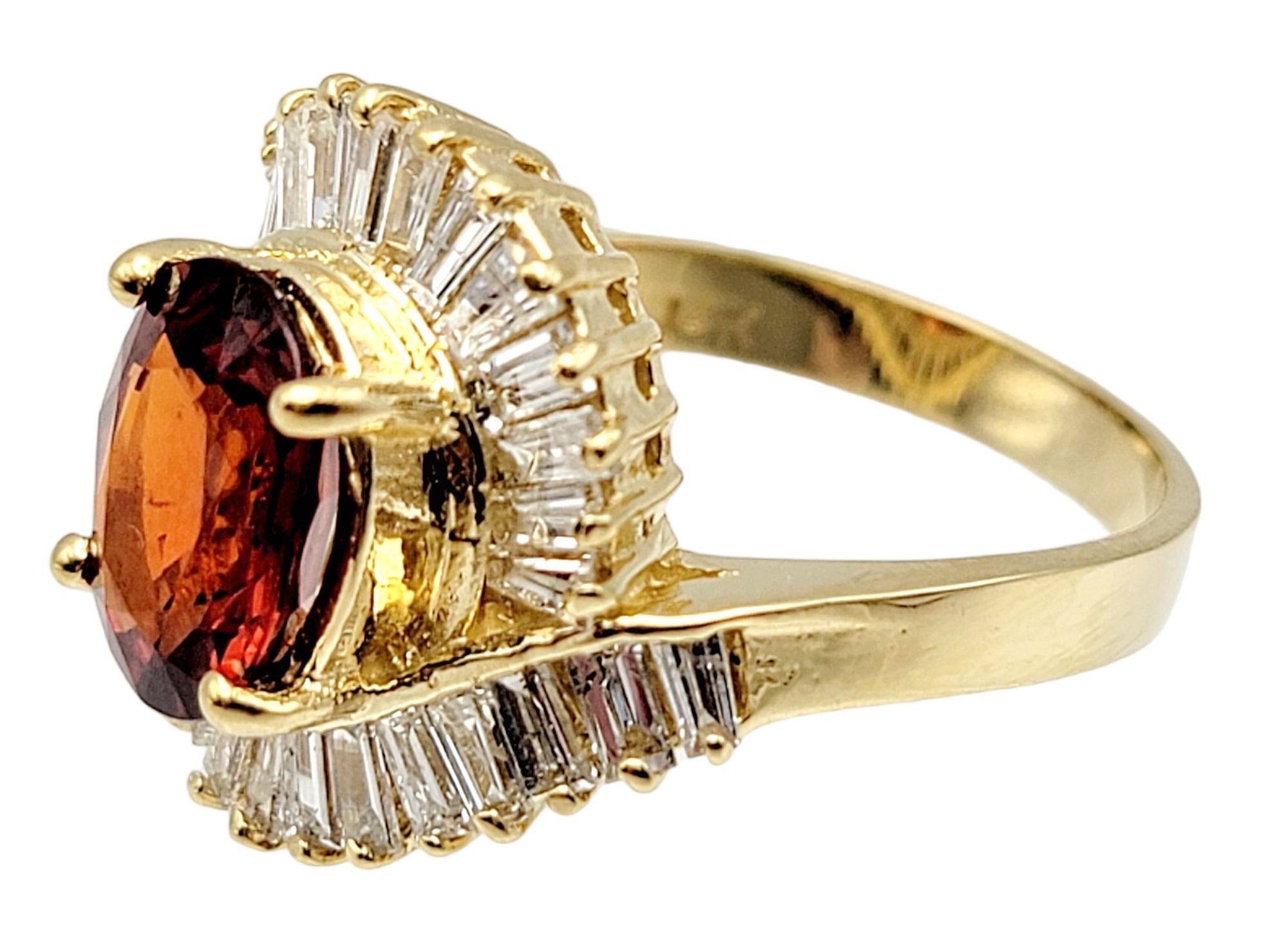 Contemporary Oval Cut Garnet and Baguette Diamond Swirl Halo Cocktail Ring in 14 Karat Gold For Sale