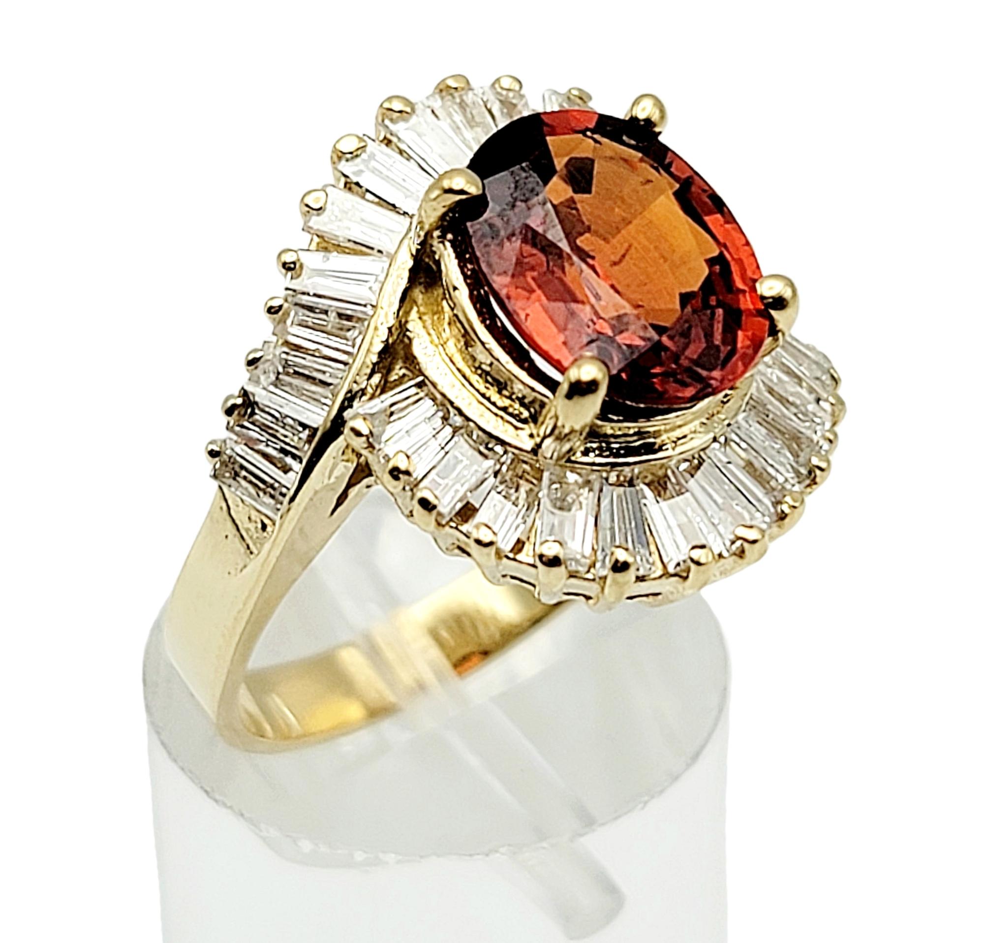 Oval Cut Garnet and Baguette Diamond Swirl Halo Cocktail Ring in 14 Karat Gold For Sale 1