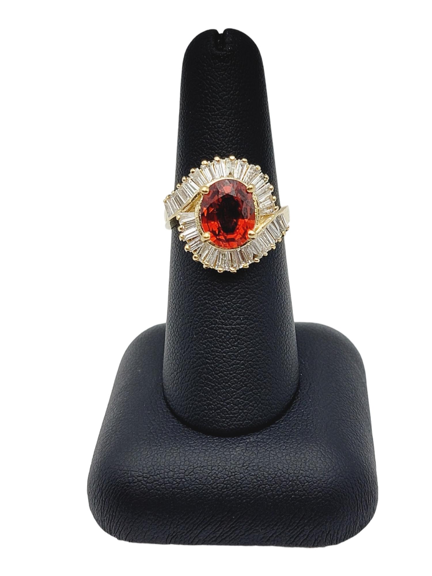 Oval Cut Garnet and Baguette Diamond Swirl Halo Cocktail Ring in 14 Karat Gold For Sale 3