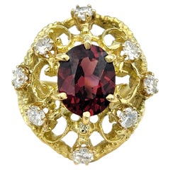 Oval Cut Garnet Open Scroll Motif Domed Cocktail Ring with Diamonds in 18K Gold
