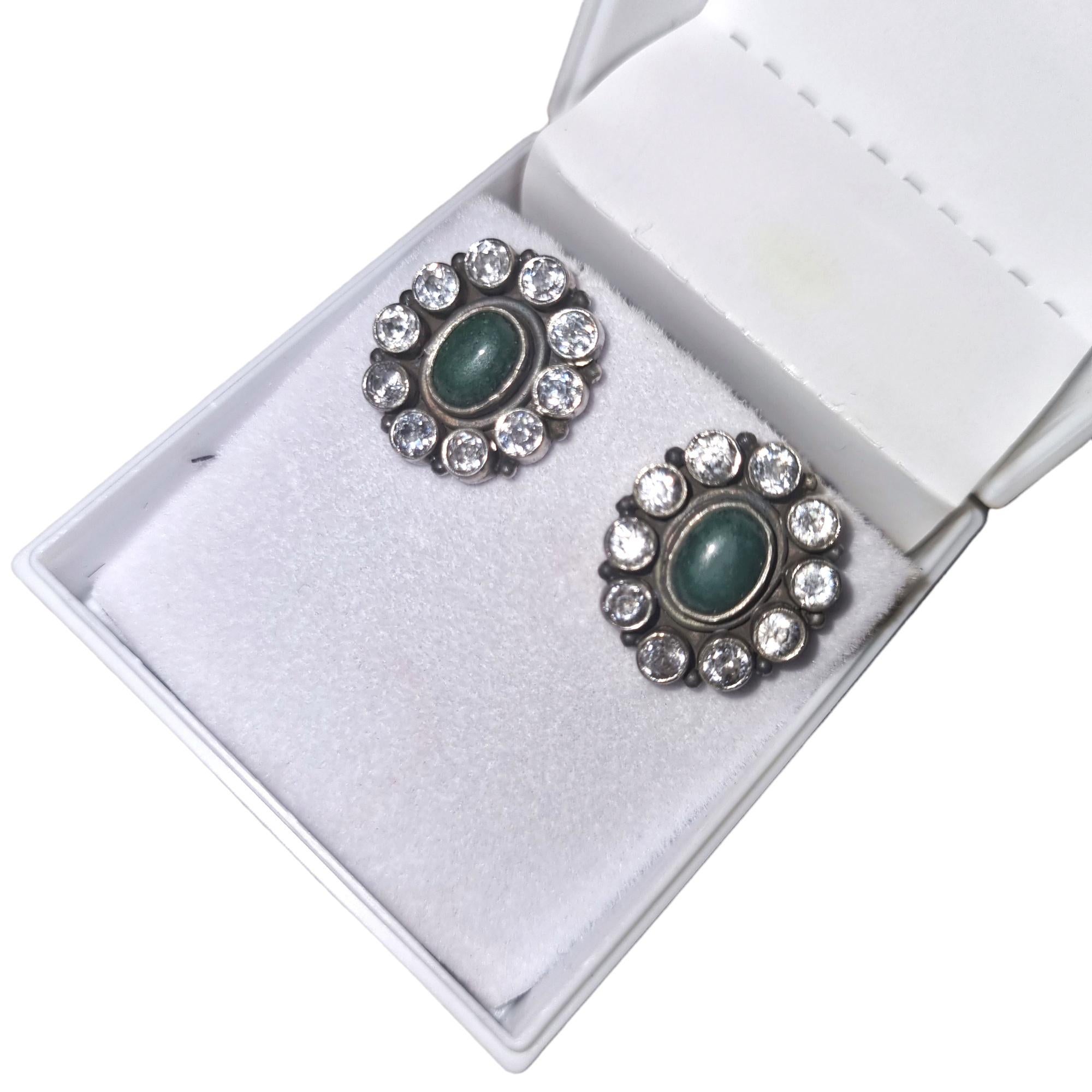 Metal - Sterling silver
Gross Weight - 7.40 Grams
Gemstones - Natural Green Onyx
Gemstone shape - Oval
Diamonds - Cubic Zirconia

Halo stud earrings with an oval-cut green onyx center stone and round cubic zirconia diamonds surrounding it are a
