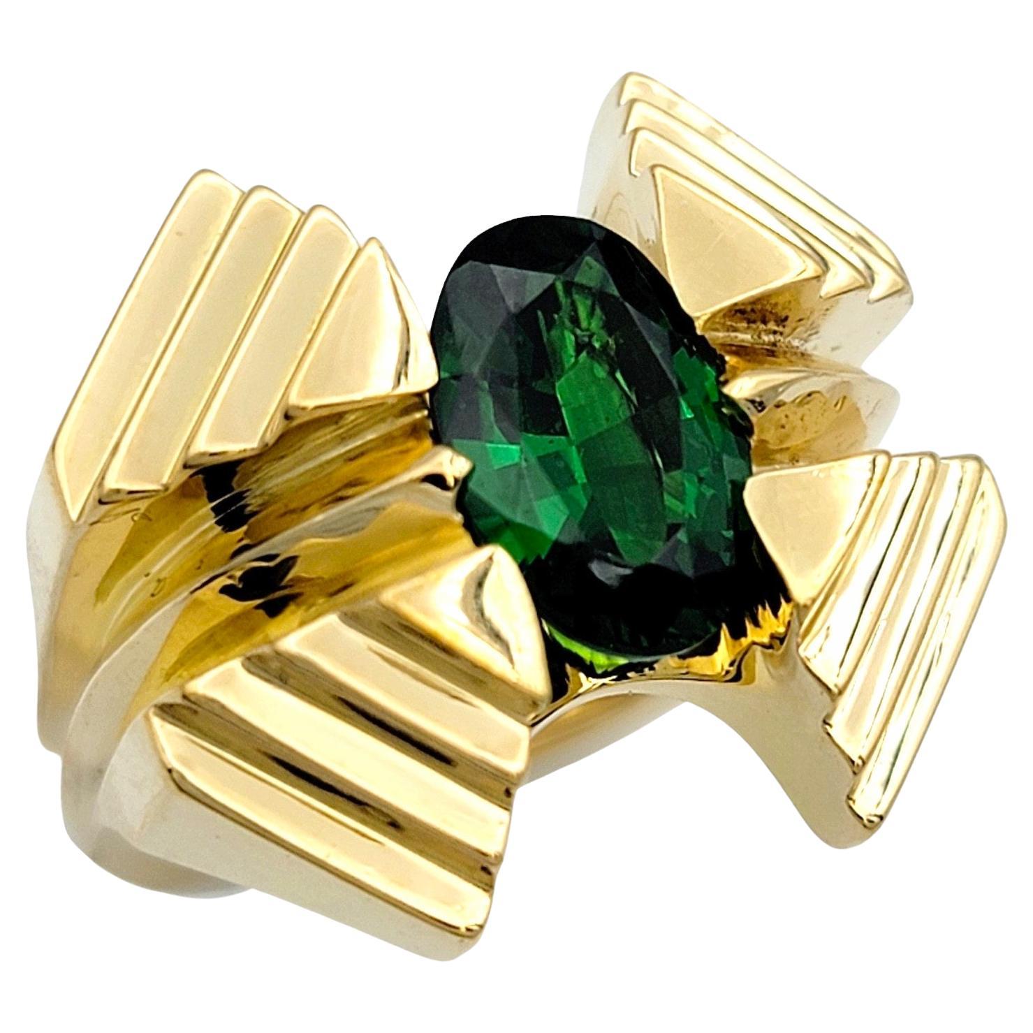 Ring Size: 7.5

This gorgeous oval tsavorite garnet ring, set in radiant 18 karat yellow gold, is a striking testament to elegance and sophistication. At its center, the vivid green tsavorite garnet gemstone captivates with its rich color and