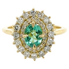 Oval Cut Halo Paraiba ring with double diamond halo in 18ct yellow gold
