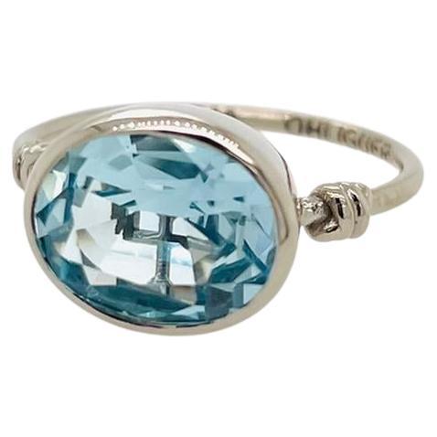 Oval cut London Blue Topaz in Love Knot Style Ring in 18ct White Gold For Sale