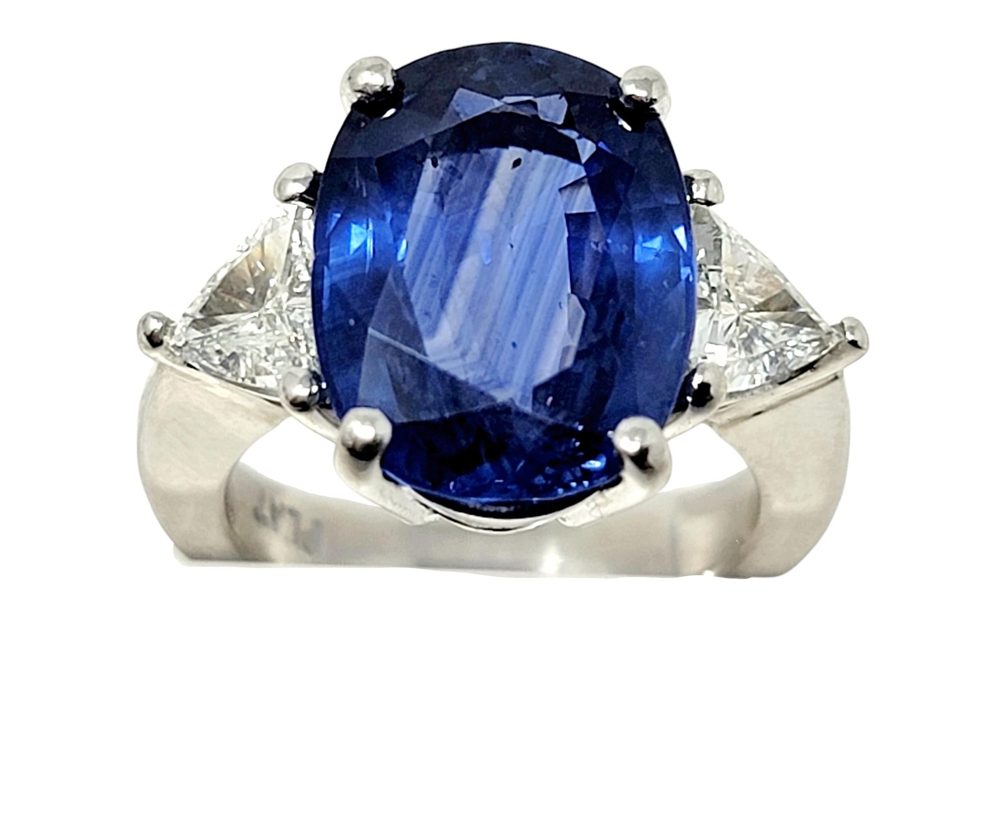 Contemporary Oval Cut Natural Ceylon Blue Sapphire and Trillion Diamond Platinum 3 Stone Ring For Sale