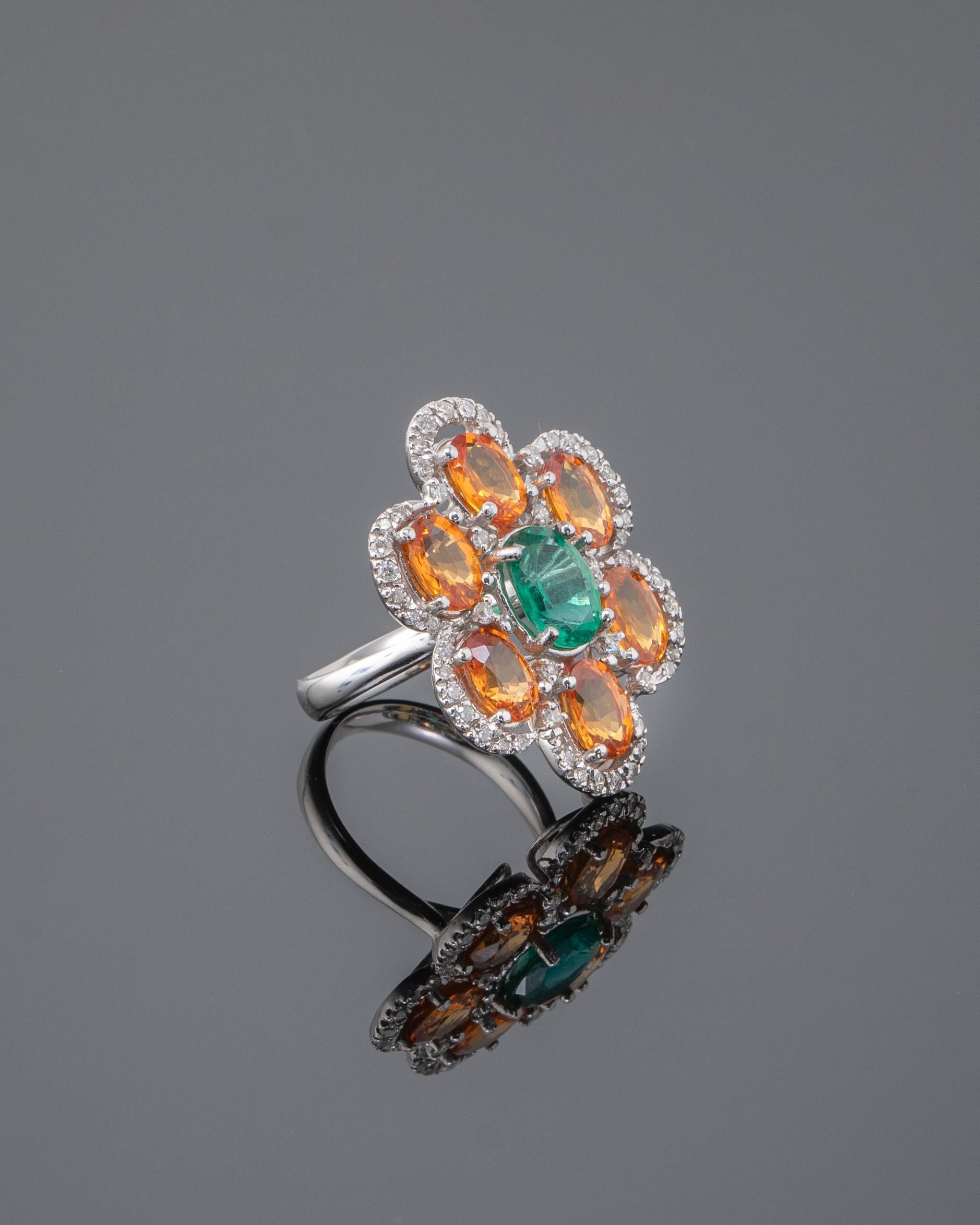 A uniquely designed cocktail ring, made of solid 8.45 grams of 18K White Gold, 6.06 carat Orange Sapphires and a 1.60 carat natural Zambian Emerald centre stone, and 0.68 carat of White Diamond. The stones are completely natural, without any