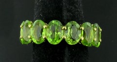 Oval Cut Peridot Eternity Band in 18 karat yellow gold