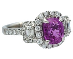 Oval Cut Pink Sapphire and Diamond Halo Three Stone Ring in Polished Platinum