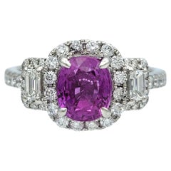 Oval Cut Pink Sapphire and Diamond Halo Three Stone Ring in Polished Platinum