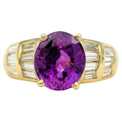 Oval Cut Purple Sapphire and Baguette Diamond Ring in 18 Karat Yellow Gold