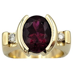 Oval Cut Rhodolite Garnet and Diamond Three-Stone Ring in 14 Karat Yellow Gold