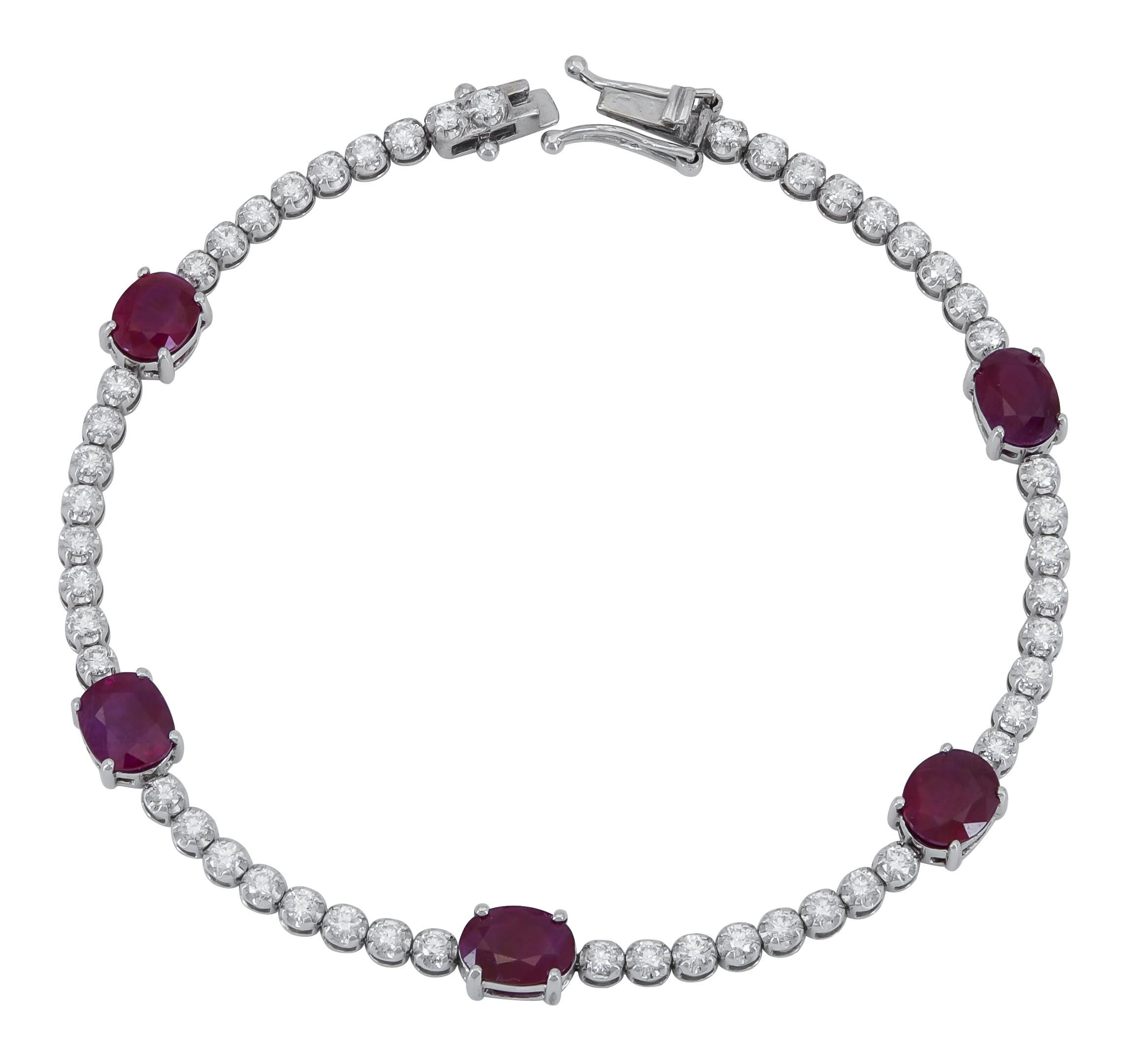 A classic tennis bracelet showcasing a row of round brilliant diamonds spaced evenly with five vibrant oval cut rubies.
Rubies weigh 9.77 carats total.
Diamonds weigh 1.39 carats total.
Dimensions: 7.00in (L) x 0.22in (W)

This item is part of our