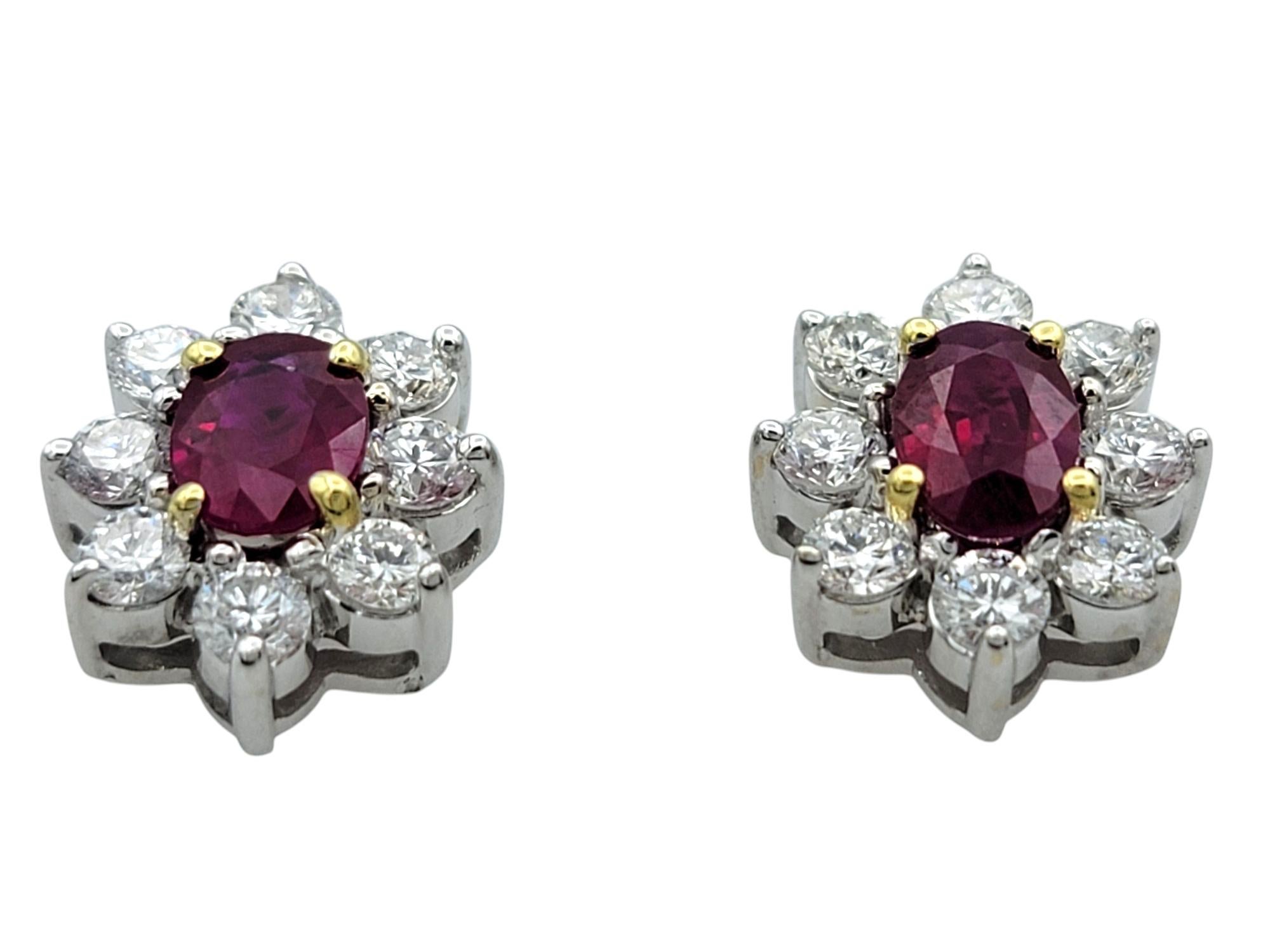 Contemporary Oval Cut Ruby and Round Diamond Halo Stud Earrings in Two-Tone 18 Karat Gold For Sale