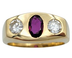 Oval Cut Ruby and Round Diamond Three-Stone Band Ring in 14 Karat Yellow Gold