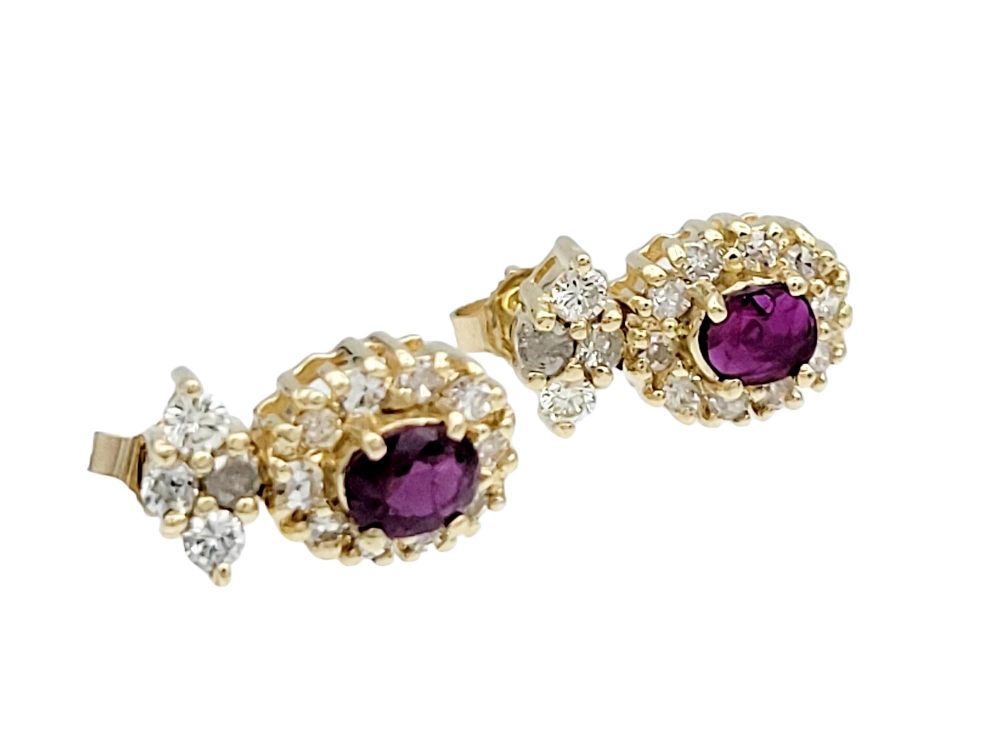 These stud earrings, set in radiant 14 karat yellow gold, are a captivating expression of classic elegance. The focal point of each earring is a lustrous oval-shaped ruby, radiating a rich and vibrant hue. Surrounding the ruby is a delicate halo of