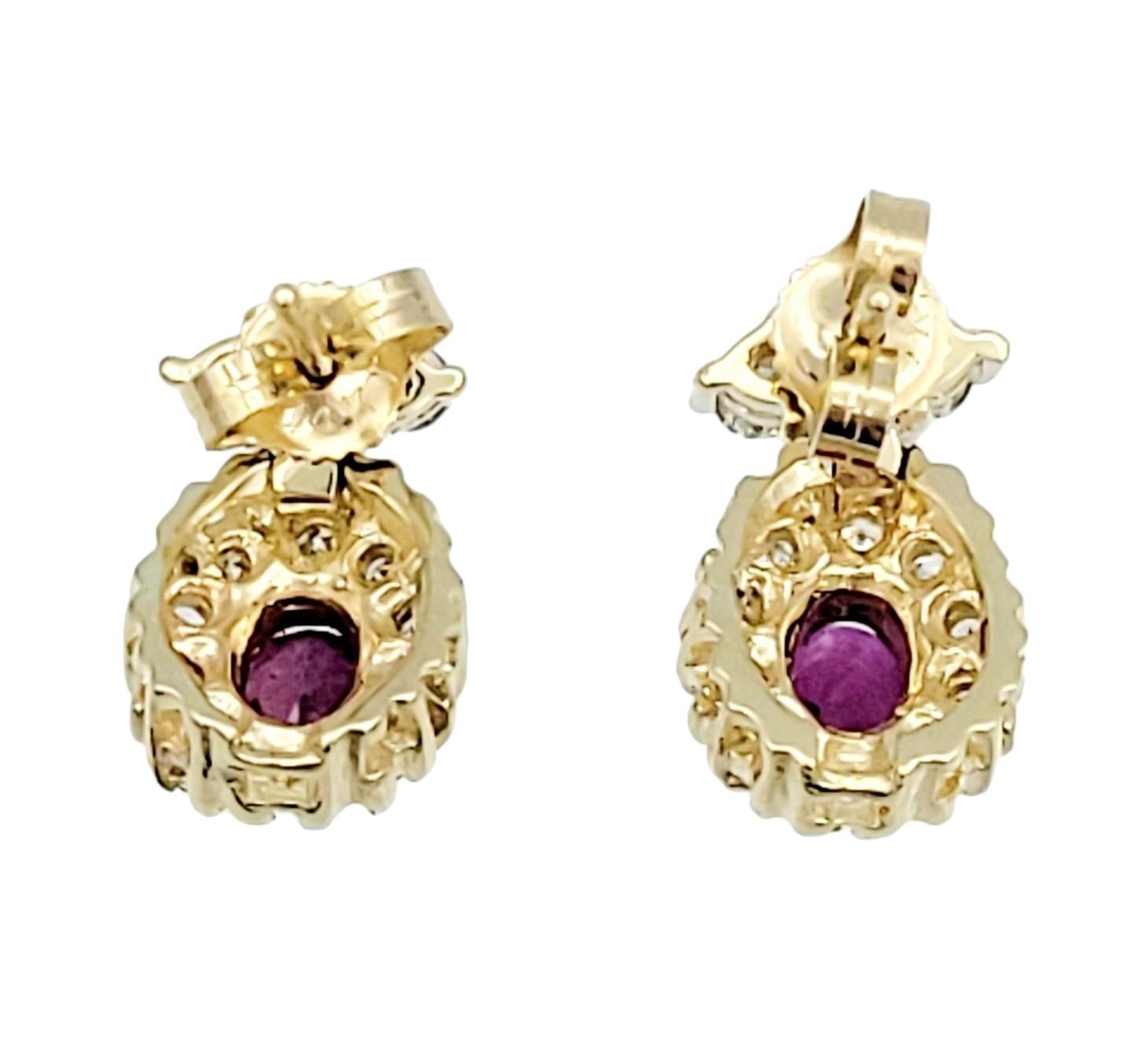 Oval Cut Ruby Earrings with Round Diamond Halos Set in 14 Karat Yellow Gold In Good Condition For Sale In Scottsdale, AZ