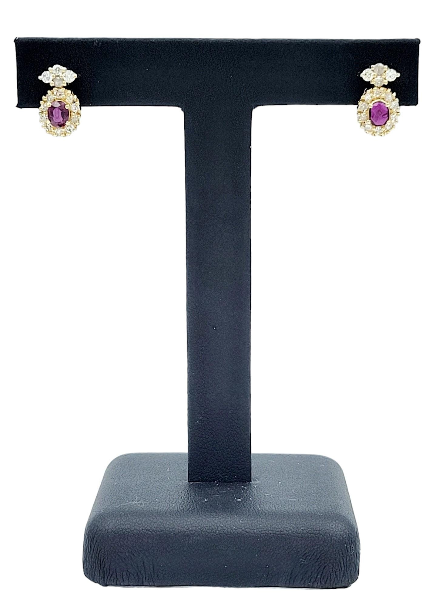 Oval Cut Ruby Earrings with Round Diamond Halos Set in 14 Karat Yellow Gold For Sale 1