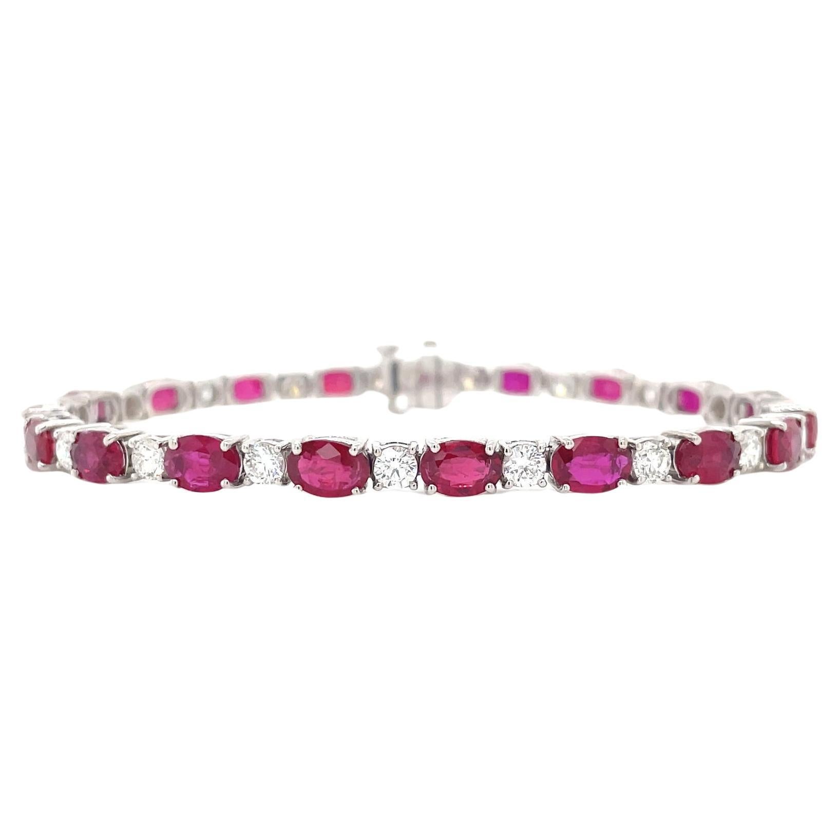 Finely matched oval cut sapphire and round brilliant diamond straight row bracelet in 18k white gold. Bracelet contains oval cut sapphires, 10.93tcw and round brilliant diamonds, 2.32tcw. Diamonds are G in color and VS2 in clarity. All stones are
