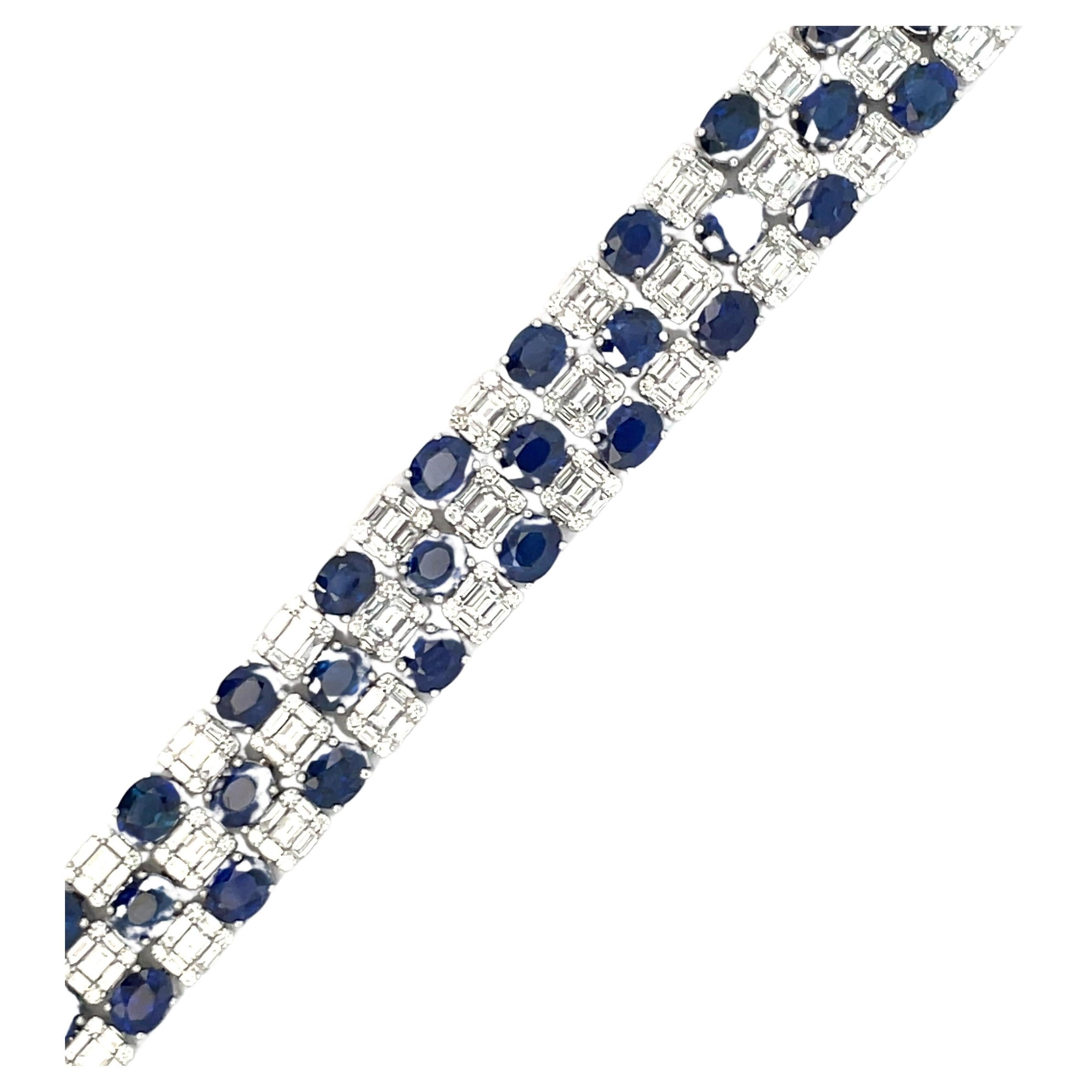 Fifty oval cut blue Sapphires weighing 24.02 Carats with alternating illusion style diamonds containing 234 round brilliants 1.49 carats and 250 baguettes weighing 6.16 carats, 18 Karat White Gold. 