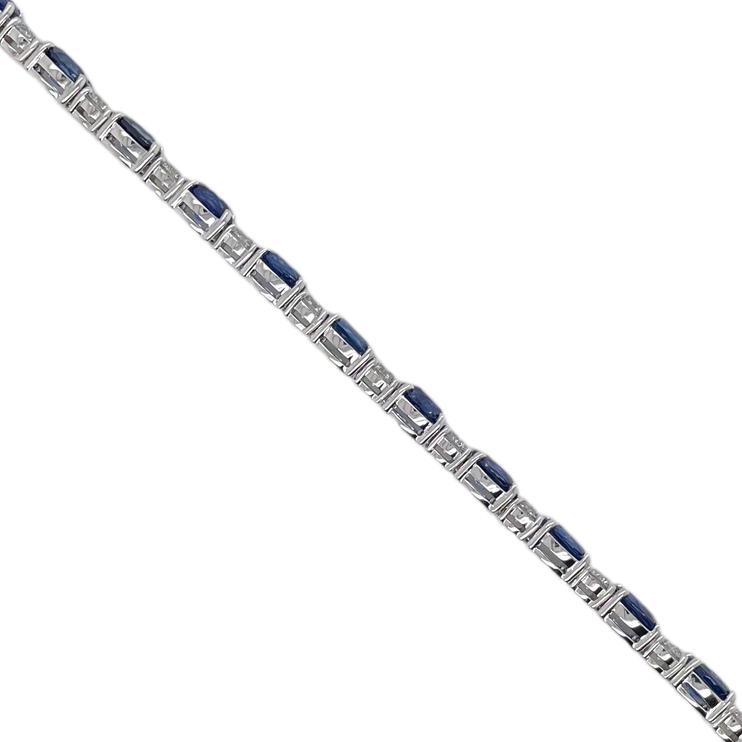Finely matched oval cut sapphire and round brilliant diamond straight row bracelet in 18k white gold. Bracelet contains 18 oval cut sapphires, 14.07tcw and 18 round brilliant diamonds, 3.50tcw. Diamonds are G in color and VS2 in clarity. All stones